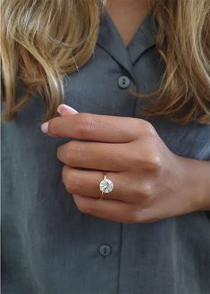 a woman's hand with a diamond ring on it