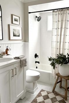 a bathroom with a checkered rug and white fixtures