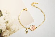 Super dainty Personalized Cherry blossom bracelet. ▶▶ You can make this necklace personal choosing the quantity of letter leaf from option. Please leave a note for the desired letters in 'add your personalization' ▶ Material - Gold plated over brass, Pearl ▶ Chain Length - 5 ~ 9 inches (Please choose it from option) ▶ charm measure - Flower H. 14mm x W. 13mm, Initial leaf ▶ The matching necklace available https://www.etsy.com/listing/196300602/cherry-blossom-necklace-sakura-necklace The matching Feminine Flower Bracelets For Wedding, Flower Charm Bracelet For Mother's Day Gift, Flower Charm Bracelet As A Gift, Cute Flower Jewelry For Gifts, Dainty Hypoallergenic Charm Bracelet For Weddings, Mother's Day Flower Charm Bracelet Gift, Cute Flower-shaped Jewelry Gift, Elegant Hypoallergenic Bracelet For Mom, Rose Gold Bracelet With Flower Charm As Gift