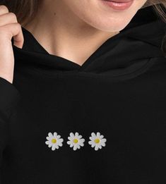 Our favorite daisy hoodie. Everyone needs a cozy go-to hoodie to curl up in, so go for one that's soft, smooth, and stylish. It's the perfect choice for cooler evenings! * 50% pre-shrunk cotton, 50% polyester * Fabric weight: 8.0 oz/yd² (271.25 g/m²) * Air-jet spun yarn with a soft feel and reduced pilling * Double-lined hood with matching drawcord * Quarter-turned body to avoid crease down the middle * 1 × 1 athletic rib-knit cuffs and waistband with spandex * Front pouch pocket * Double-needle Embroidery Hoodie Ideas, Flower Hoodie, Embroidery Hoodie, Knit Cuff, Air Jet, Daisy Flower, Pocket Pouch, Rib Knit, Fabric Weights