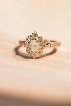 a diamond ring sitting on top of a wooden table