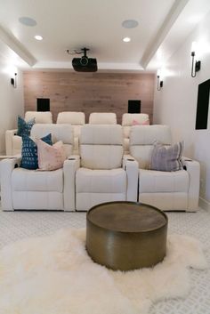 a white couch and some chairs in a room