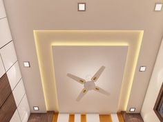 a ceiling fan in the middle of a room with white tiles on the walls and wood flooring