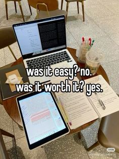 an open laptop computer sitting on top of a wooden table