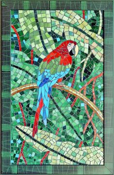 a colorful parrot sitting on top of a tree branch in a stained glass window frame