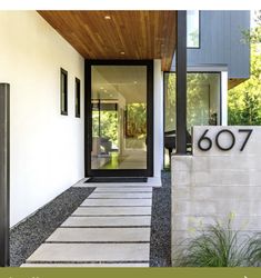 the entrance to a modern home with black and white accents