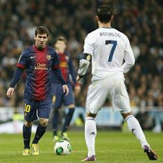 two soccer players are on the field during a game, one is about to kick the ball