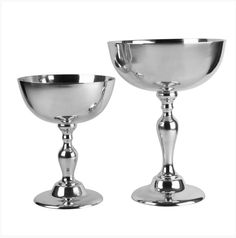 two silver goblets sitting next to each other