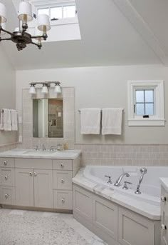 a large bathroom with two sinks and a bathtub