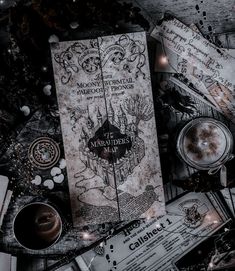 harry potter's map surrounded by other items on the table with candles and decorations