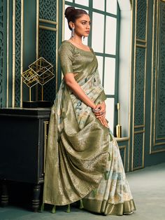 Introducing our exquisite off-white and olive green cotton saree, a perfect blend of traditional charm and contemporary elegance. This saree is crafted with meticulous attention to detail, featuring intricate digital print work that adds a modern touch to its classic design. The rich weaving pallu and the intricately designed weaving border enhance its regal appearance, making it a timeless piece suitable for any occasion. The soft cotton fabric ensures maximum comfort, allowing you to drape it White Digital Print Saree For Wedding, White Cotton Silk Saree With Printed Border, Festive White Saree With Digital Print, Elegant White Saree With Printed Border, Green Cotton Silk Saree With Printed Border, Green Cotton Silk Saree With Printed Motifs, Green Traditional Wedding Wear With Printed Border, Green Digital Print Saree For Wedding, Green Saree With Digital Print For Diwali