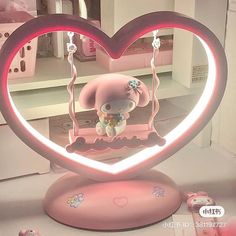 a pink heart shaped display with a teddy bear inside