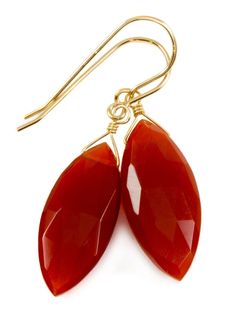 Carnelian Earrings Carnelian faceted marquise cut earrings Rich burnt orange in color, stone size 10x23mm Neutral color, works with lots of outfits Earrings hang 1.6 inches, 25 carats Great everyday "go to" earrings Available in sterling or 14k solid gold or filled finishes Mannequin shows how they will hang Please note photos show camera lighting, shadows and reflections. Jewelry comes packaged in a small colorful tie pouch. Gemstones may have been treated to improve stability, durability or ap Hang Earrings, Carnelian Earrings, Earthy Jewelry, Orange Carnelian, All Gems, Fine Jewellery Earrings, Gemstone Earrings, Burnt Orange, Jewelry Pieces