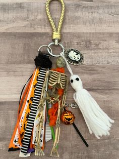 a keychain that has various items attached to it on a wooden surface,