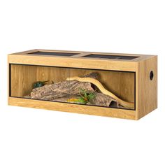 a wooden box with an animal in it's habitat and plants inside the enclosure