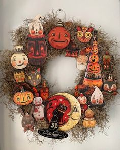 a wreath made out of pumpkins and other decorations