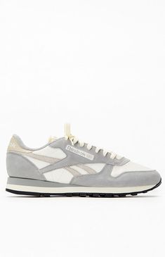 The Reebok Classic Leather Shoes in gray pay homage to their 1983 debut as running shoes turned fashion icons. This version blends old-school charm with a blend of nylon and suede on the upper, complemented by touches of color and an asymmetrical logo for a modern twist on a legendary design.PLEASE NOTE: This shoe is offered in Men's sizes; please consult the Size Chart above - the conversion is a size and a half smaller for women. For example, a woman who is a size 7.5 should order a size 6 in Men's.Leather and suede upperTextile liningLace closureEVA midsoleRubber outsole Reebok Mens Gray Classic Leather Shoes size 10 Gray Leather Sneakers For Running Errands, Vintage Gray Sneakers With Round Toe, Retro Gray Sneakers With Round Toe, Retro Gray Low-top Sneakers, Beige Skin, Reebok Classic Leather, Charm School, Fashion Icons, Reebok Classic