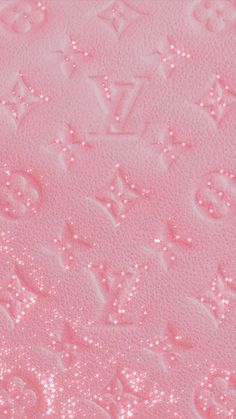 a pink background with the letters louis vuitton written in white and silver glitters