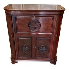 a wooden cabinet with two doors and drawers