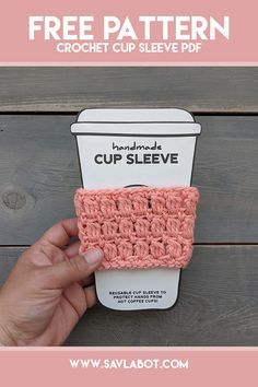 a cup sleeve made out of crochet is being held up by someone's hand