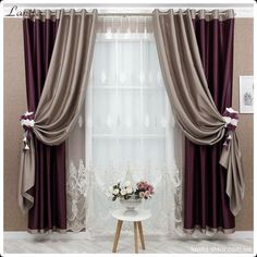 a living room with curtains and flowers on the table