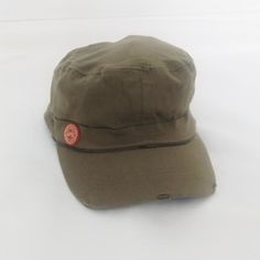 a brown hat with a red patch on it