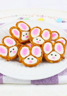 a plate filled with bunny shaped pretzels on top of a purple and white table cloth