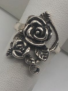 a silver ring with a rose on it