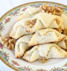 several pastries on a plate with walnuts