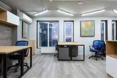 an empty office with desks and chairs