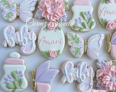 decorated cookies are arranged in the shape of baby's first names and other items