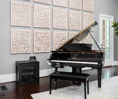 a living room filled with furniture and a grand piano in front of a large wall