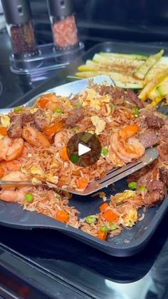 a plate full of food on top of a table with french fries and carrots