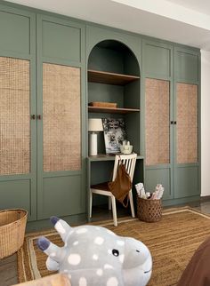 a room with green cabinets and a stuffed animal