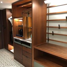 a room with some shelves and drawers in it