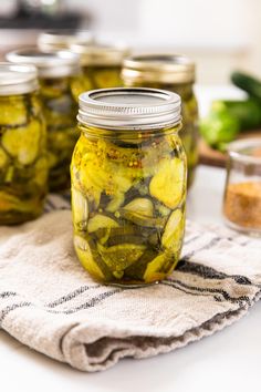 pickles in jars sitting on a towel