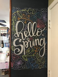 a chalkboard with the words hello spring written on it