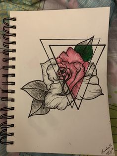 a drawing of a pink rose on top of a piece of paper