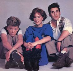 an album cover with two men and a woman sitting on the floor next to each other