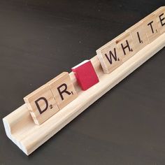 the word dr written in scrabble type blocks with a red tie on them