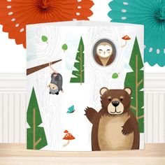 there is a bear and two other animals in the forest with paper fans behind it