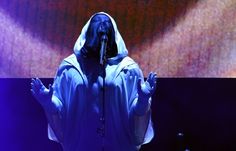 a person in a hooded costume on stage