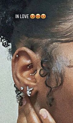 an image of a woman with ear piercings on her nose and the caption in love