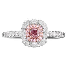 GIA Certified Fancy Light Purplish Pink Diamond Engagement Ring Introducing an exquisite ladies' diamond ring that exudes elegance and luxury, perfect for marking special occasions or as a timeless piece of everyday sophistication. This stunning diamond ring features a center stone that is GIA certified Fancy Light Purplish Pink diamond, weighing 0.25 carats. The captivating pink diamond is expertly cut to showcase its unique hue and sparkle, making it the focal point of this beautiful ring. Sur