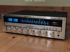 an old stereo receiver sitting on top of a wooden table