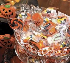 a bowl full of halloween candy with pumpkins and jack - o'- lanterns