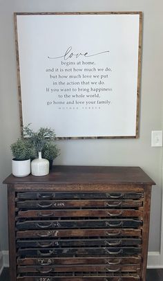 a wooden dresser with drawers and a sign above it