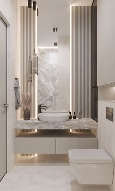 a modern bathroom with marble counter tops and white walls, along with a large mirror on the wall