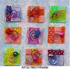 nine square pieces of art with different designs and colors on the sides, each one has a spiral design