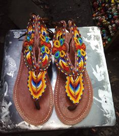 Traditional Multicolor Beaded Flip Flops, Traditional Brown Beaded Sandals, Traditional Multicolor Toe Post Sandals, Traditional Beaded Flip Flops For Festivals, Bohemian Embellished Adjustable Sandals, Bohemian Adjustable Embellished Sandals, Bohemian Embellished Sandals For Vacation, Adjustable Brown Beaded Sandals, Bohemian Beaded Closed Toe Flip Flops